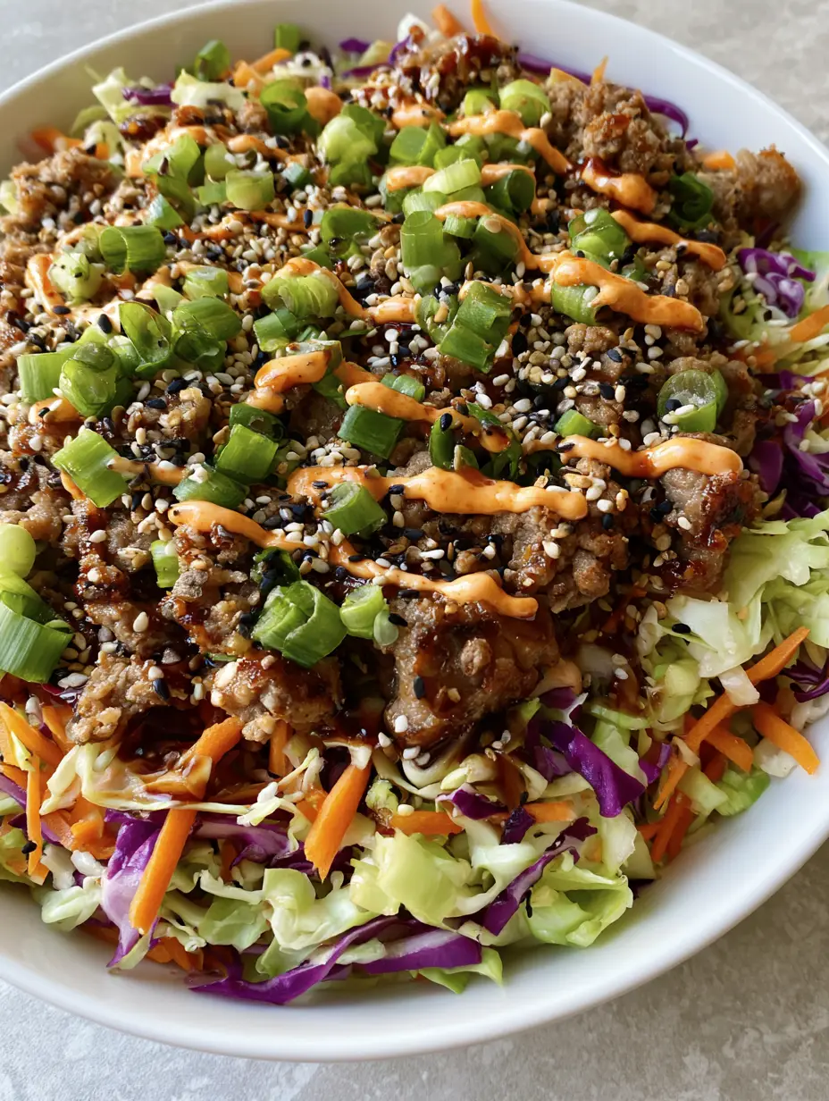 High-angle close-up of Egg Roll in a Bowl showing caramelized ground pork and glossy ginger soy sauce.