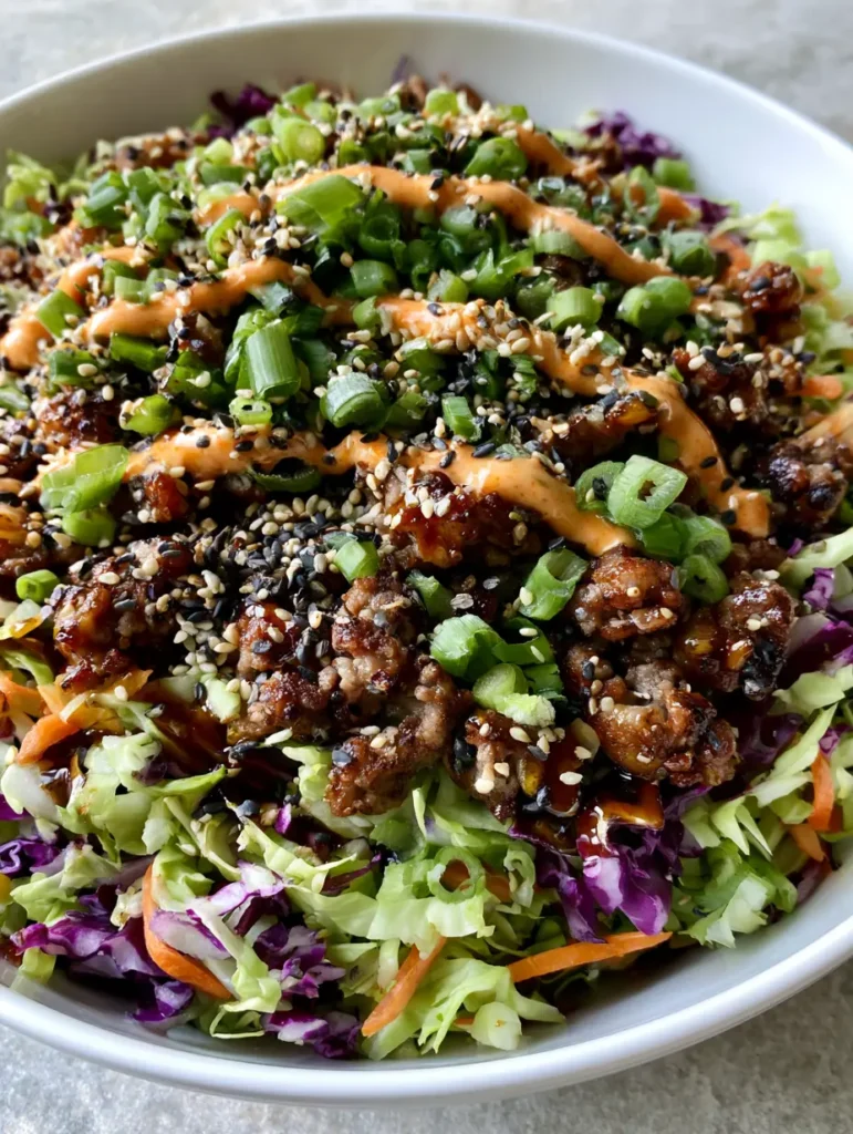 A detailed shot of the tender-crisp shredded cabbage and purple cabbage in an Egg Roll in a Bowl.