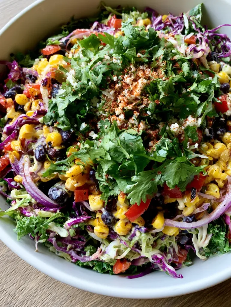A top-down view of Cowboy Cabbage Salad topped with fresh cilantro and tajin seasoning.