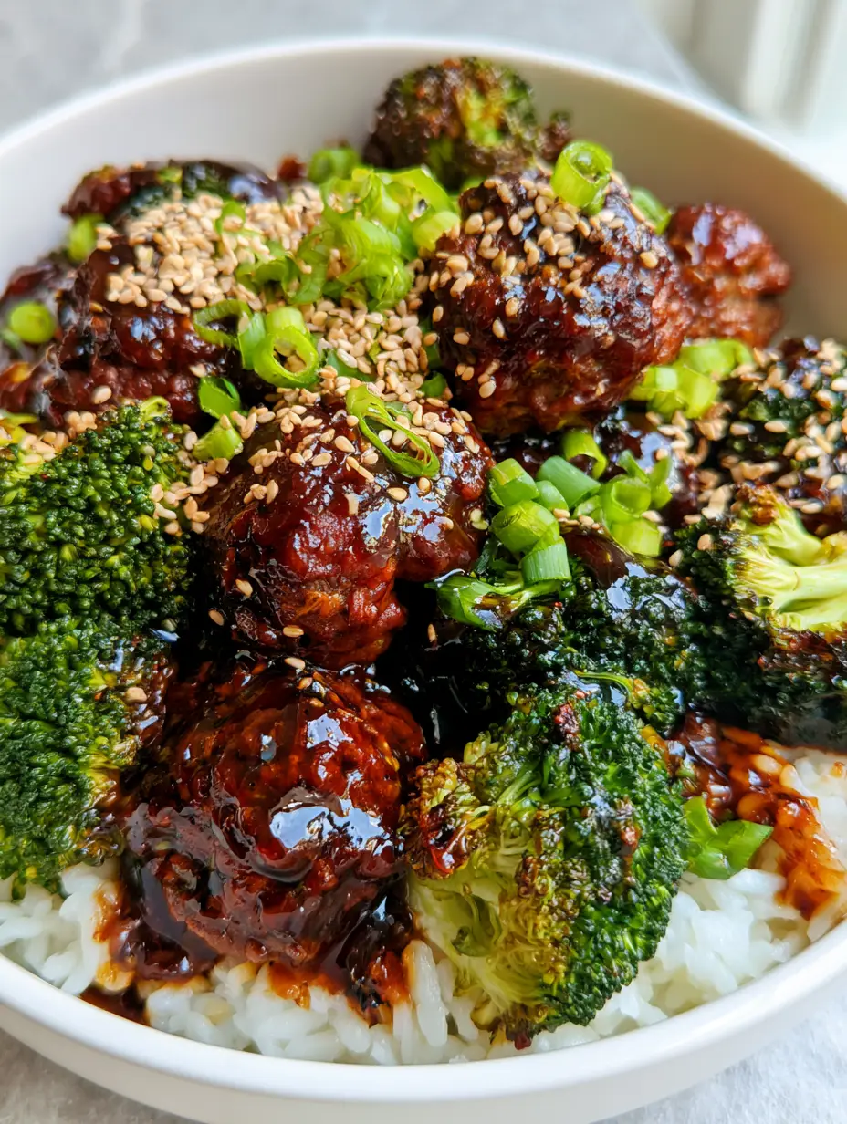 Sticky Mongolian Meatballs with Glossy Mahogany Glaze 3 Close up view of Sticky Mongolian Meatballs showing the thick reflective glaze and toasted sesame seeds garnish.