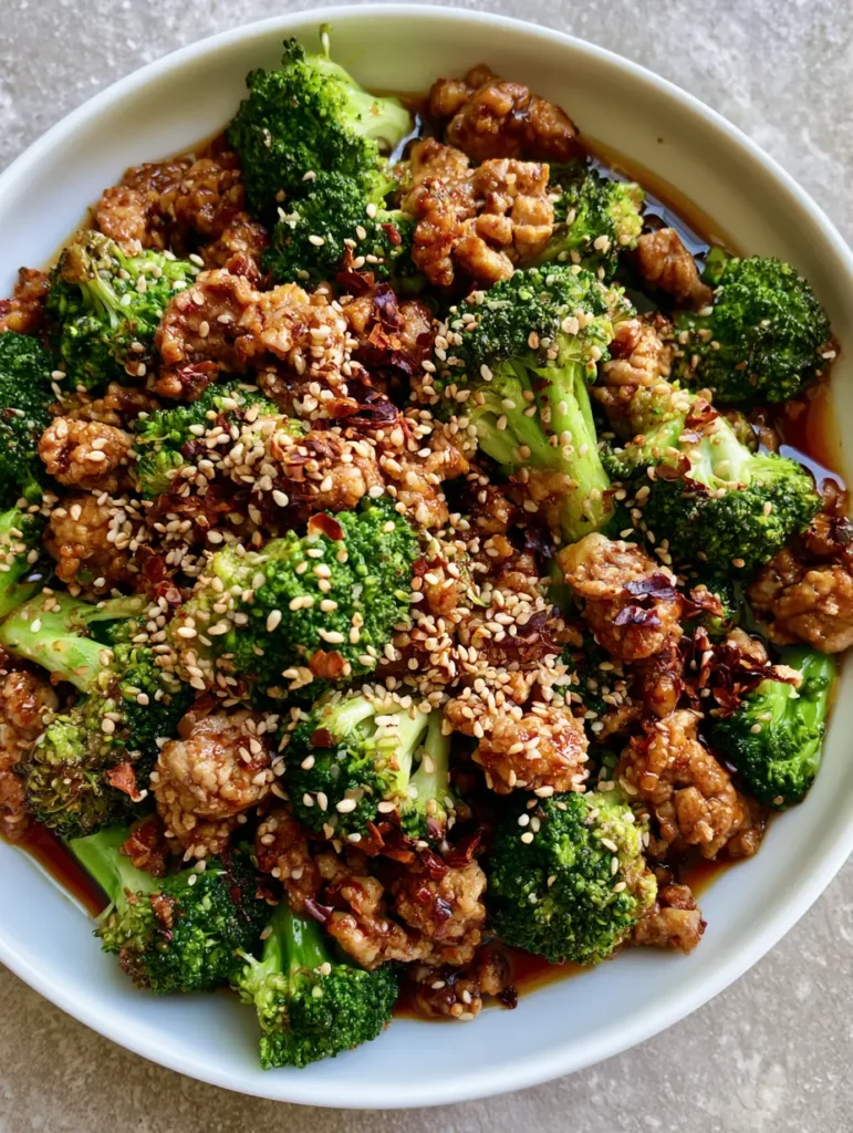 Top-down shot of Ground Turkey Stir Fry showing the vibrant contrast of red pepper flakes and white sesame seeds.